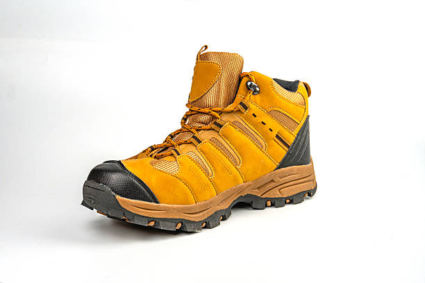 istock A high-resolution image of a single bright yellow hiking boot on a neutral background, designed for durability and traction, with a robust sole, reinforced toe, and lace-up closure 2211490821