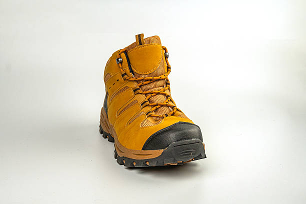 istock High-resolution image of a sturdy hiking boot, showcasing details such as reinforced toe cap, deep tread sole for off-road stability, possibly waterproof or water-resistant material Suitable for out 2211490907