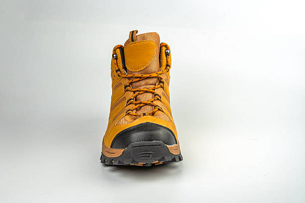 istock Image shows a single hiking boot with sturdy construction, lace-up closure, rugged sole for various terrains, suitable for outdoor activities like hiking or trekking, brown color scheme, and earthy l 2211490925