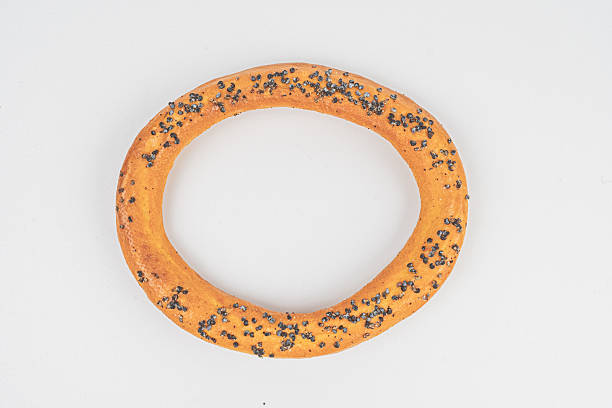 istock Image shows a circular donut with a hole forming another ring, possibly sesame seed-topped and presented against a plain background for advertising purposes 2211490994