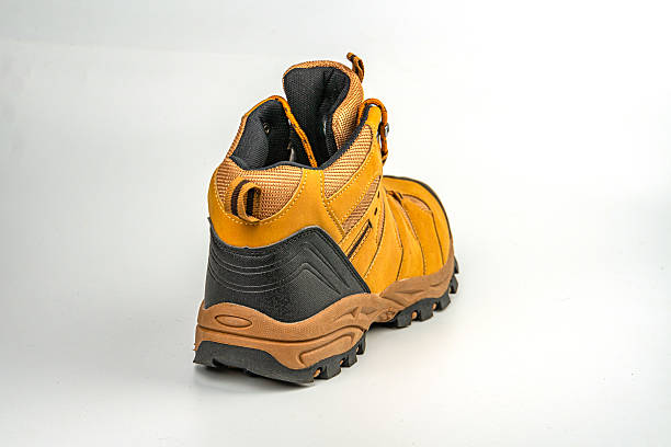 istock Image shows a single hiking boot, brown and black with traction soles, designed for rugged terrains The design includes laces at the top and reinforced areas for durability during outdoor activities 2211491007
