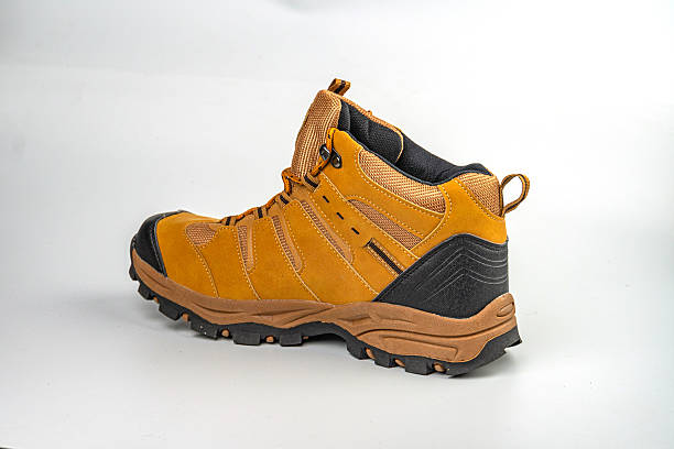 istock Image shows a single sturdy hiking boot on a neutral background, designed for outdoor activities It has multiple lacing points, earthy brown suedeleather upper, reinforcement around heel and toe ar 2211491009