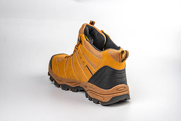 istock Robust, high-top hiking boot with sturdy sole and deep treads, designed for outdoor activities Brown and contrasting colors 2211491012