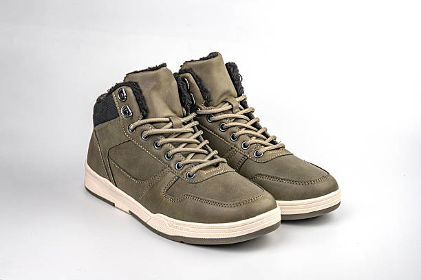 istock Robust olive green hiking boots with durable laces, sturdy treads, waterproof material, and suede-like finish, targeting outdoor enthusiasts 2211491391