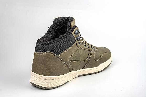 istock A side view of a lace-up, rugged yet stylish hiking or work boot Features include sturdy sole, thick rubber tread for grip, reinforced toe cap, metal eyelets, and possibly textured upper material 2211491559