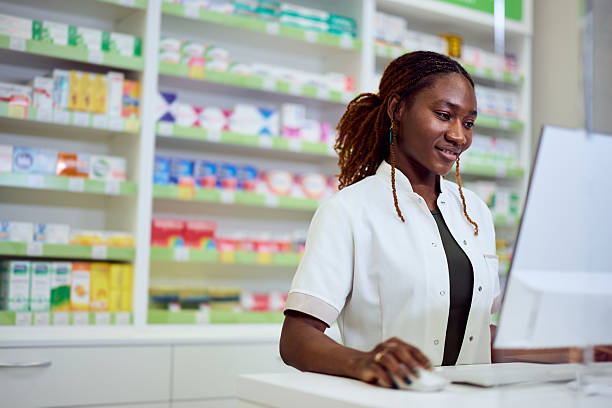 istock Friendly Pharmacist Working at the Counter in a Modern Pharmacy 2211493470