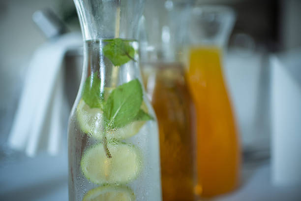 istock Enjoying Refreshing Beverage Carafes beautifully garnished with Mint and Citrus Fruit Slices 2211493666