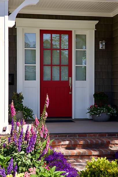 istock Charming beach house with bright red door 2211506548