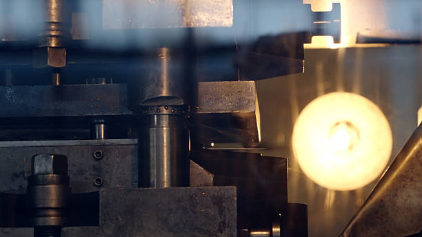Automation in metal machine parts production in modern factory. Modernization in the manufacturing, industrial sector and smart infrastructure concept.