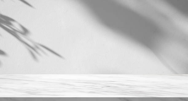 istock Marble table with tree shadow drop on white wall background for mockup product display 2211508455