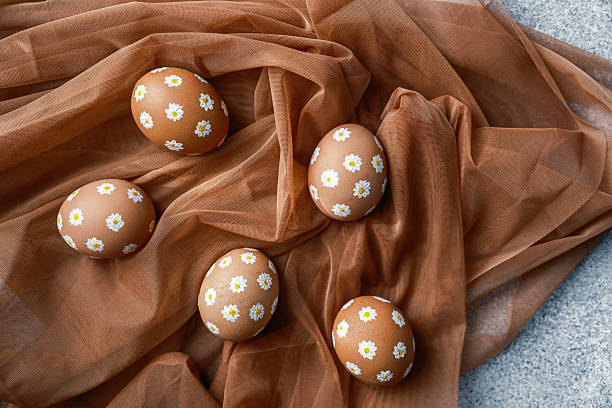 istock Decoratively painted eggs arranged on soft fabric during festive celebrations 2211508734