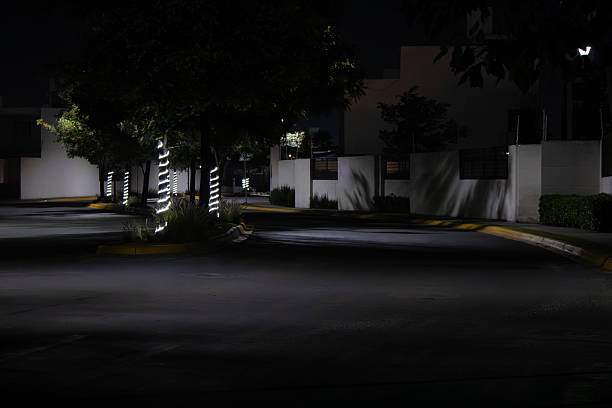 Young woman using her mobile phone at night with the city at background