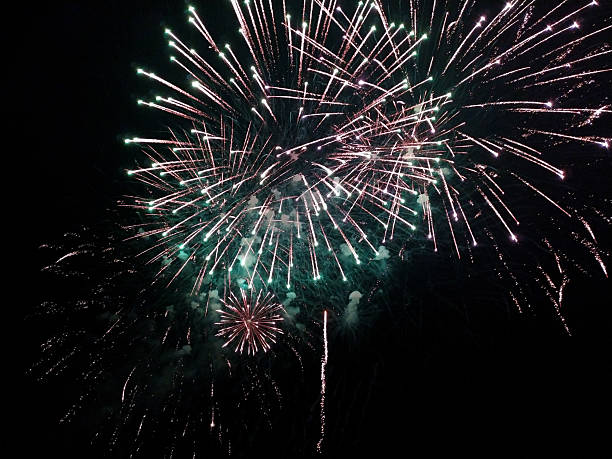 Vibrant fireworks explode against a night sky, radiating celebration. Dynamic display of color and light. Perfect for holiday, event, or festive themes.
