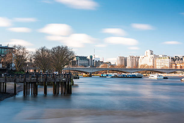 istock Lambeth bridge over river thames in london, england, with moving clouds 2211509697