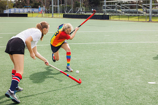 istock Female field hockey player in action 2211509910