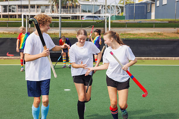 istock Junior hockey players celebrate scoring a goal 2211509969