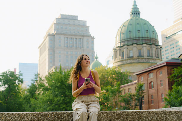 istock Woman using smartphone in Montreal, Canada 2211510032