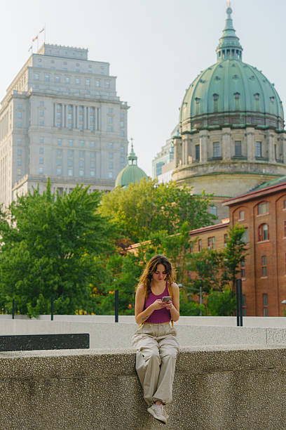istock Woman using smartphone in Montreal, Canada 2211510033
