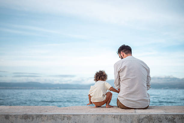 istock Caring Caucasian Father and Diverse Son Enjoying Seaside Moments 2211510077