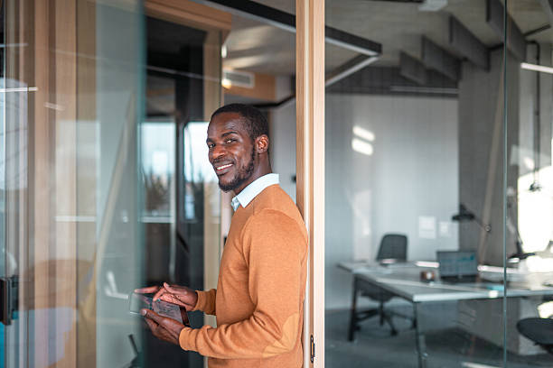 istock Confident Black Businessman Engages with Digital Tablet in Office 2211510168