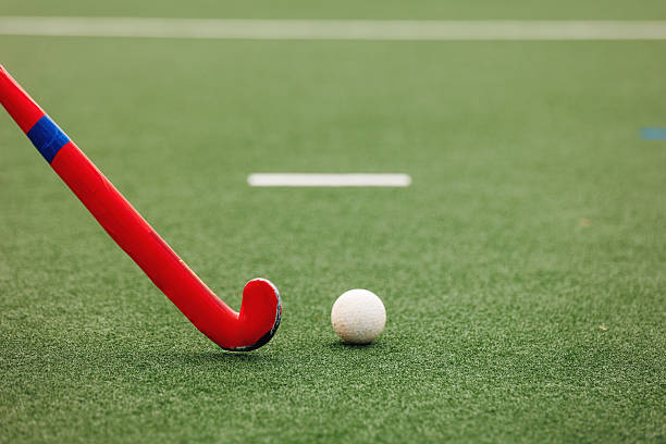 istock Field hockey stick and ball on artificial turf pitch 2211510528