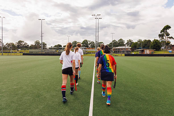 istock Two field hockey teams line up before taking part in community match 2211510567