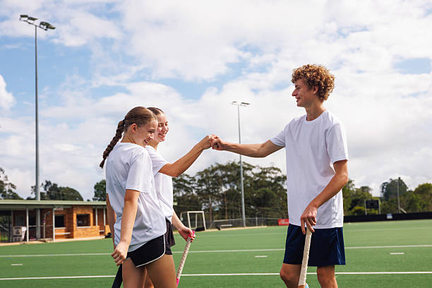 Junior hockey players celebrate scoring a goal