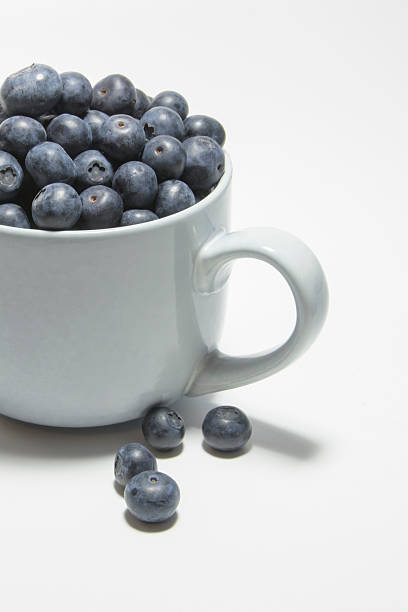istock Blueberries on a white background on a large cup of ripe berries 2211512126