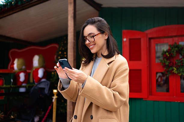 istock Woman using smartphone outdoor autumn day 2211519602
