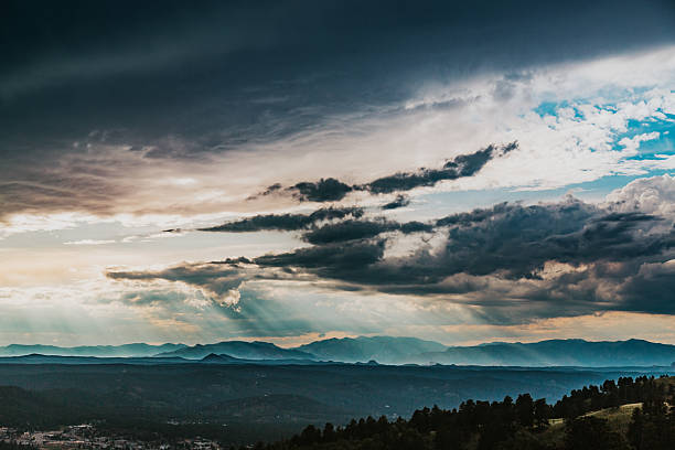 Sun rays through storm clouds over mountains in Colorado in Colorado Springs, Colorado, United States