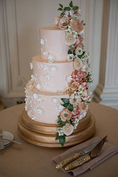 istock Three-tier blush floral cake with gold base 2211520608