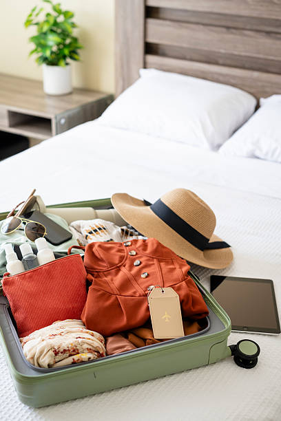 istock Luggage on bed fully packed for traveling 2211520656