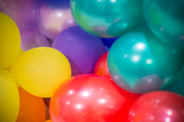 Horizontal shot of bunch of silver golden white and blue colored shiny party balloons for happy cheerful celebrations backdrops, background, wallpaper