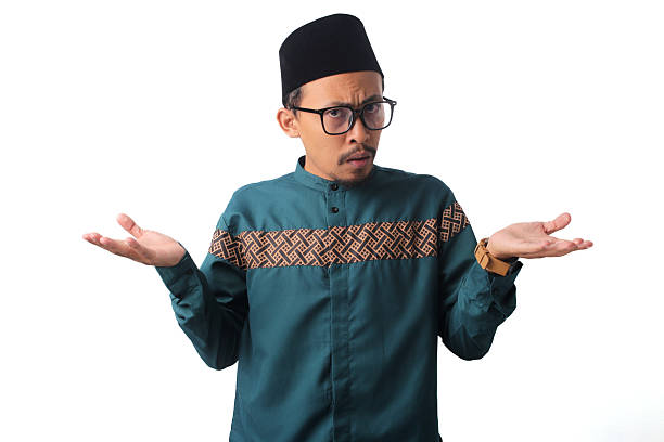istock Clueless and Unaware Asian Muslim Man Expressing Doubt and Uncertainty 2211526713
