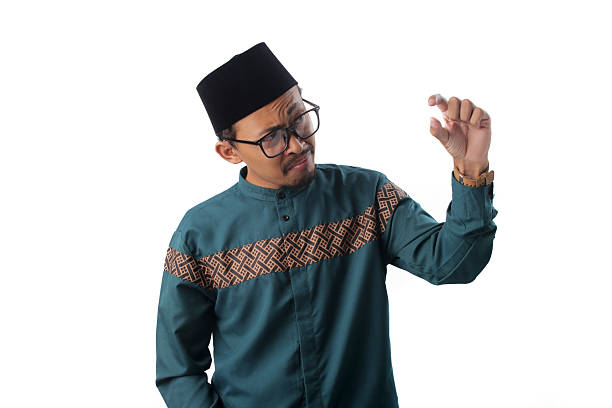 istock Displeased Asian Muslim Man Gesturing with Hand Doing Small Size Sign 2211526787