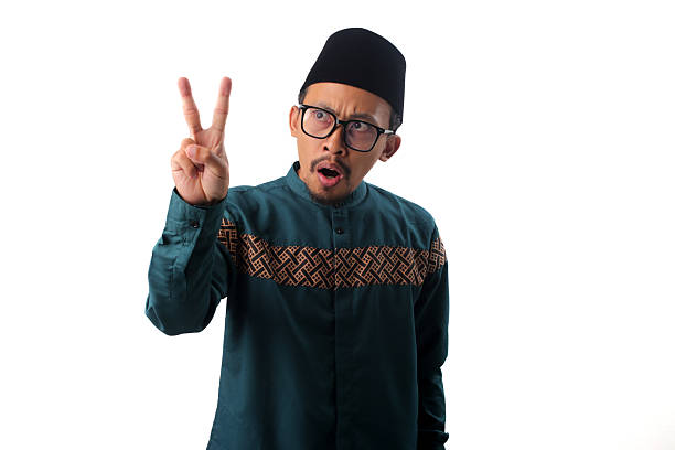 istock Surprised Asian Muslim Man Showing Number Two Gesture 2211527668