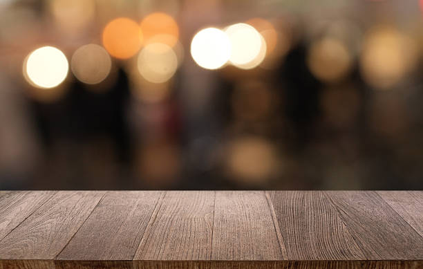 istock Empty wood table top and blur of restaurant background selective focus product display 2211528684
