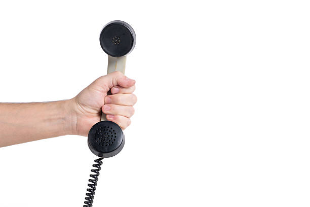 Closeup hand holding telephone receiver on white background