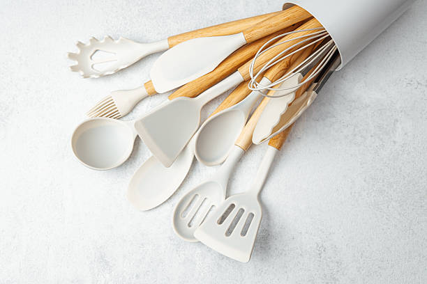 istock Collection of kitchen utensils arranged in a white container on a marble surface 2211532330