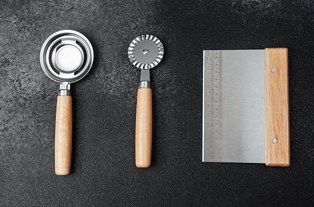 istock Kitchen tools for baking and food preparation on a dark countertop 2211532342