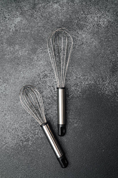 istock Kitchen whisks on dark countertop ready for baking or cooking use 2211532345