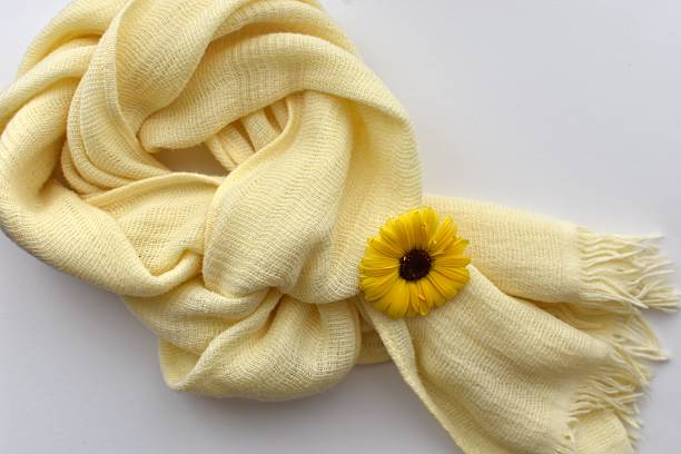 Close-up soft cotton scarf and beautiful fresh yellow flowers