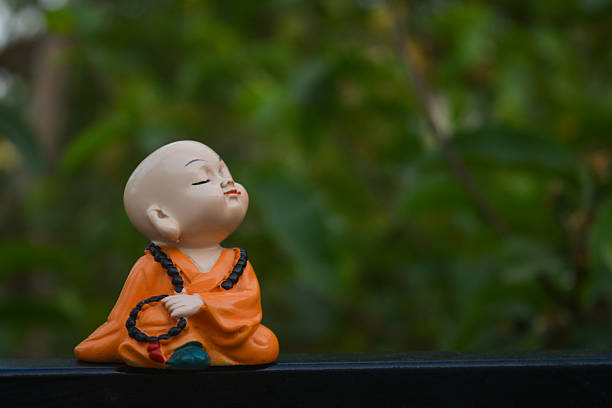 Cute little asian buddha statue. Buddhist monk