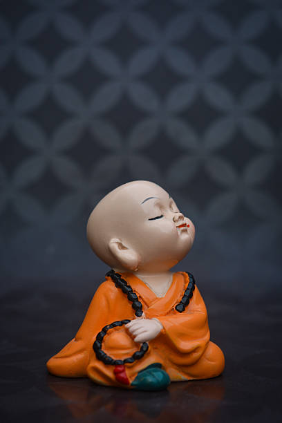 Cute little asian buddha statue. Buddhist monk