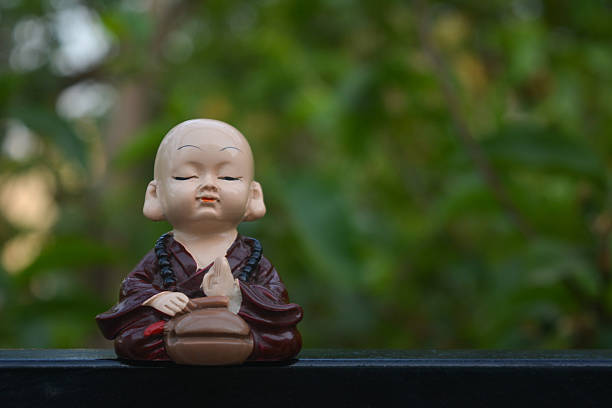 white Buddha figurine in white ambience with atmospheric lighting