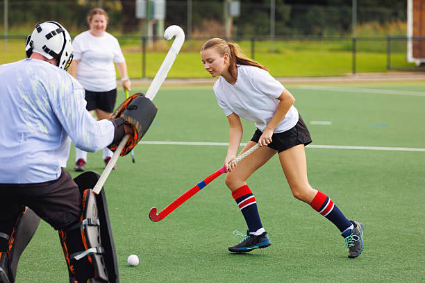 istock Female field hockey player in action 2211534099