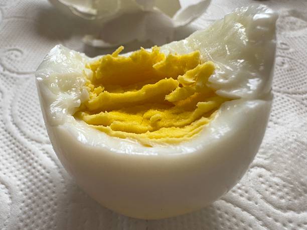 istock A bitten hard-boiled egg with a bright yolk lies on a white napkin 2211534637