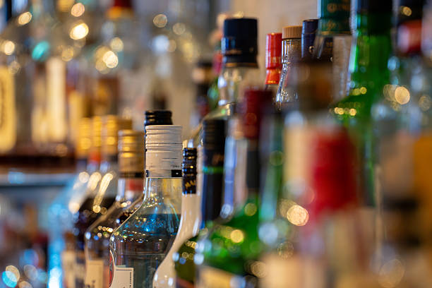 istock Assorted liquor bottles on a bar shelf. 2211535165