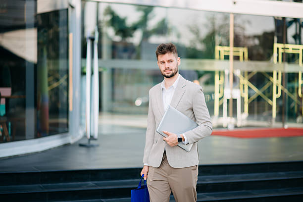 istock Successful Businessman in suit using tablet outdoors. Perfect for corporate, technology, and professional themes 2211535644