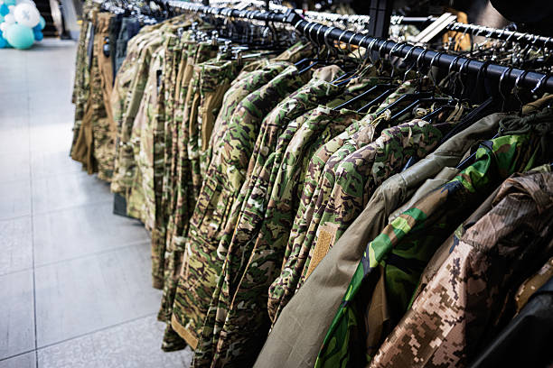 istock Rack filled with various camouflage patterned clothing displayed in a retail store 2211535739